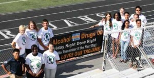 LHS CORE students with their “Friday Night Done Right” banner.