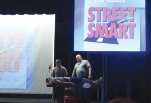 Street Smart presenters enlist a student volunteer to demonstrate life-saving efforts.