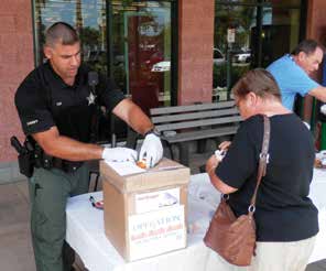 Cpl. Ronny Turi assists a resident at an Operation Medicine Cabinet event in Collier County. The Collier County Sheriff’s Office partners with Drug Free Collier to hold Operation Medicine Cabinet initiatives several times a year as a way for residents to easily and safely dispose of their unwanted medications. Photo by Cpl. Efrain Hernandez/CCSO