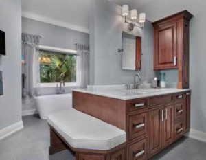 A BEAR’S PAW HOME REMODEL INCLUDED THE TRANSFORMATION OF THE MASTER BATH WITH BACK-TO-BACK HIS & HER VANITIES, SOAKING TUB, GLASS COUNTERTOPS AND CUSTOM BENCH AND ECO-GREEN CABINETRY.