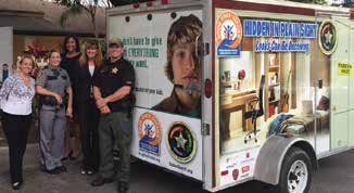 Melanie Black and Katherine Gutierrez of Drug Free Collier along with Captain Beth Jones, Sgt. Jeff Boyd and Cpl. Alison DiSarro of the Collier County Sheriff’s Office unveil the new traveling exhibit