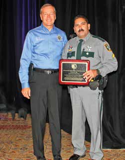 COLLIER COUNTY SHERIFF KEVIN RAMBOSK, LEFT, PRESENTS CPL. KEN VILA WITH THE 2015 FLORIDA D.A.R.E. OFFICER OF THE YEAR AWARD IN ORLANDO IN JULY. IN AUGUST, CPL. VILA TRAVELED TO NEW ORLEANS WHERE HE WAS HONORED BY D.A.R.E. AMERICA WITH THE 2015 NATIONAL D.A.R.E. OFFICER OF THE YEAR AWARD. PHOTO BY CPL. DEBRA GROSS/CCSO