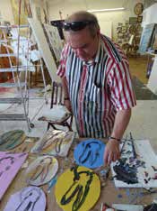 Hunt Slonem in his studio working on paintings at various stages of completion