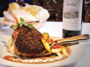 YABBA’S NEW MENU OFFERS DISTINCTIVE CHEF CREATIONS SUCH AS THE PORK AU POIVRE, A 14-OUNCE BONE IN PORK CHOP PAN SEARED AND SERVED WITH A GREEN PEPPERCORN CREAM SAUCE, SOUR CREAM MASHED POTATOES AND FRESH ISLAND VEGETABLES. PHOTO BY KEITH ISAAC PHOTOGRAPHY