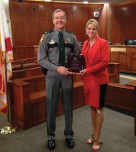 Sheriff Kevin Rambosk accepts the David S. Crawford Law Enforcement Officer Victim Services Award from Florida Attorney General Pam Bondi at a ceremony in Tallahassee on April 9. The Shelter For Abused Women & Children nominated Sheriff Rambosk for the prestigious award for his service in the community on behalf of victims of domestic. Photo by Sgt.Wade Williams/CCSO