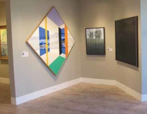 THE PAINTING ON THE RIGHT IS A BLACK-ON-BLACK PAINTING BY JIMMY ERNST DEPICTING THE FLORIDA EVERGLADES. IN-PERSON YOU CAN SEE THE SAWGRASS MEADOWS AGAINST THE FLAT FLORIDA HORIZON, BUT IN THIS PICTURE ALL YOU SEE IS A BLACK SQUARE. THE PAINTING CAN BE SEEN AT HARMON-MEEK|MODERN, 382 12TH AVE S IN OLD NAPLES.