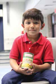 Alejandro and his family receive food from a pantry at Avalon Elementary School